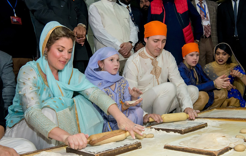 Canadian Prime Minister, John Trudeau, with his family performing langar.